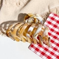 Macro shot of large marble-pattern hair claw clip with golden metal spring detail - Khaki Marble Texture (M-2508)