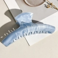 Detailed macro view of the curved marble hair claw clip with sky blue acetate texture - Grey Blue