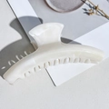 Detailed top view of a marble pattern hair claw clip on an aesthetic background - Beige