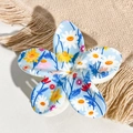 Detail shot of sky blue frangipani hair claw clip with daisy print on beige woven background - Sky Blue White Red Small Flower Style / ABS
