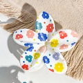 Detailed close-up of a floral print egg flower hair claw clip on a soft beige fabric - White Multicolored Small Flower Style / ABS