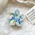 Detailed macro view of cream floral hair claw clip with blue daisy patterns on white paper - Blue Fresh Floral Style (116-5)