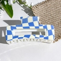 Detail of blue and white checkered square claw clip on a textured white surface - Sky Blue and Off-white Wavy Checkerboard Style (152-2)