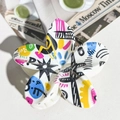 Detail view of flower hair claw clip with colorful graffiti patterns on white glossy surface - ABS / Bright White Multicolor Graffiti-ABS Beige 155-2