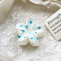 Close-up of white floral hair claw with blue heart patterns and inner teeth detail - Blue Heart Dot Style (126-1)