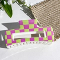 Macro shot of large square hair claw with purple and green checkered UV print pattern - Fluorescent Green and Purple Checkerboard Style (151-2)