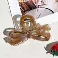 Detailed close-up of amber translucent bow hair claw with elegant aurora glitter finish - Coffee Small Bow Style