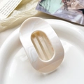 Elegant cream marble oval hair claw clip with cutout design on a ceramic plate - 10cm Round Clip - Marble Beige