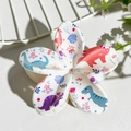 Detail view of flower-shaped hair claw clip with cute cartoon dinosaur UV printing - Cartoon Dinosaur Print (139-1)