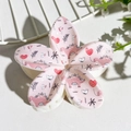 Detailed macro view of large pink flower claw clip with colorful cartoon dinosaur patterns - Light Pink Dinosaur Print (139-6)