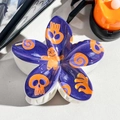 Macro shot of Halloween purple flower hair claw clip with orange skull and ginger man prints - 8cm Uv Printed Frangipani Flower - Abs Beige 02-8 / ABS