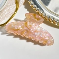Detailed close-up of marble pattern hair claw clip with golden glitter in a tray - 9cm Square Head Style / Iridescent Pink