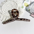 Macro view of large leopard print hair claw clip on a stylish white textured table - 13cm Cross-Glossy Beige Leopard