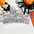 Macro shot of Halloween claw clip with ghost and pumpkin prints on leather background - Solid Square - Cute Ghost