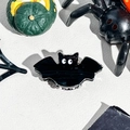 Primer plano de una pinza para el pelo de murciélago negro con fondo de Halloween - Murciélago Blanco y Negro
