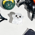 Close-up of cute ghost hair clip with white pearl texture for Halloween festive decor - Smiling Ghost