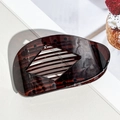 Detail view of tortoiseshell acetate hair claw with hollow rhombus design and inner teeth - Glossy Dark Brown (Leopard)