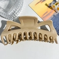 Detail view of large matte cream hair claw clip with strong grip teeth on white surface - Large Monster (13.5cm) / Milk Coffee