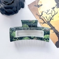 Close-up of Halloween hair claw clip with dark green skull pattern on white leather background - 8.5cm Printed Square Green Skull (005-01)