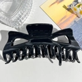 Close-up of 14cm large black matte shark hair clip with strong grip teeth on white texture - Large Monster (13.5cm) / Bright Black