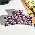 Macro shot of Halloween hair claw clip featuring white skull pattern on purple acetate material - 8.5cm Printed Solid Square Purple All-over Skull (005-06)