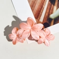 Detail of pink marble textured acetate flower hair claw clip on white card display - Orange Pink