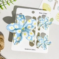 Three-piece light blue daisy floral hair clip set with UV print on display card - Light Blue with White Daisies (UV Printed Plumeria 3-Piece Set - ABS-118-7)