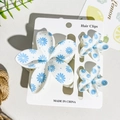 Set of three white flower hair claws with blue daisy print on display card - White Base Blue Daisy Style (UV Printed Frangipani 3-Piece Set, ABS-126-6)