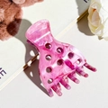Detailed close-up of pink marble texture hair claw clip with round cutout design - Pink Purple