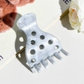 Detailed close-up of grey marble pattern hair claw clip with stylish circular cutouts - Smoke