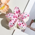 Detailed macro view of pink flower hair claw clip with strawberry and bow print - Plumeria Pink (8cm)