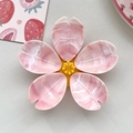 Detail view of 3D cherry blossom fridge magnet with pink marble texture and yellow center - Single Layer - Marble Pink