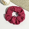 Detailed view of burgundy ribbed fabric scrunchie with elegant natural folds texture - Burgundy