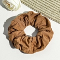 Detail of caramel corduroy hair scrunchie showing fine ribbed texture and fabric finish - Caramel