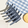 Detail view of large matte dark grey hair claw clip on lifestyle fabric background - Matte Blue Gray