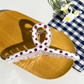 Detail view of large checkered hair claw clip with red dots on a wooden background - Cross Red Polka Dot (12.5cm)