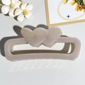 Detail of cream rectangular hair claw clip with double heart design and hollow base - Lotus root pink