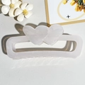 Detail view of translucent white heart-shaped rectangular hair claw on leather background - Transparent Cream White