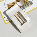 Detail of square hollow hair claw clip with cream marble texture in lifestyle setting - Square Clip / 9.5cm / Beige