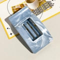 Detailed view of the blue marble texture and hollow design on this rectangle hair claw - Gray Blue