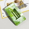 Macro detail of a rectangular green marble pattern acetate hair claw clip for thick hair - Cyan Green