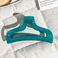 Detailed view of the teal fishtail hair claw clip with a glossy translucent finish - Transparent Peacock Blue
