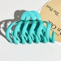 Detail of Tiffany blue soft silicone pumpkin hair claw clip showing smooth finish and teeth - Peacock Green