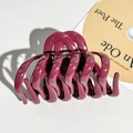 Close-up of a burgundy silicone pumpkin hair claw clip with strong metal spring - Burgundy