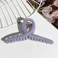 Dettaglio di un fermaglio per capelli in resina viola traslucida con molla in metallo dorato - Viola Grigio