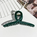 Close-up of dark green jelly color hair claw clip with golden metal spring and cross design - Dark Green