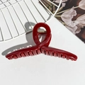 Detailed view of dark red glossy hair claw clip with golden metal spring for elegant styling - Burgundy