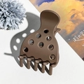 Detailopname van de donkerbruine matte haarklem met unieke ronde uitgesneden vormen - Mat Donkere Koffie