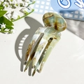 Detailed view of acetate hair fork with vintage green marble texture and long prongs - Coffee Green