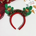 Detail view of Christmas headband with sequined antlers and Merry Christmas star ornaments - Green Antlers Raffia